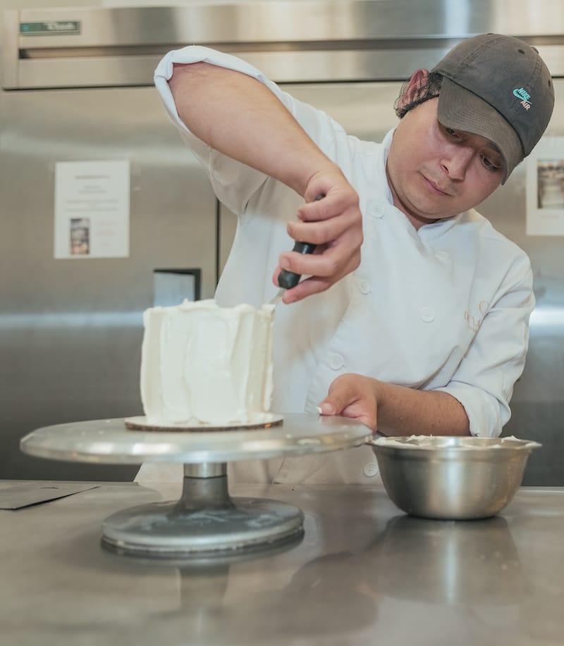 man frosting cake