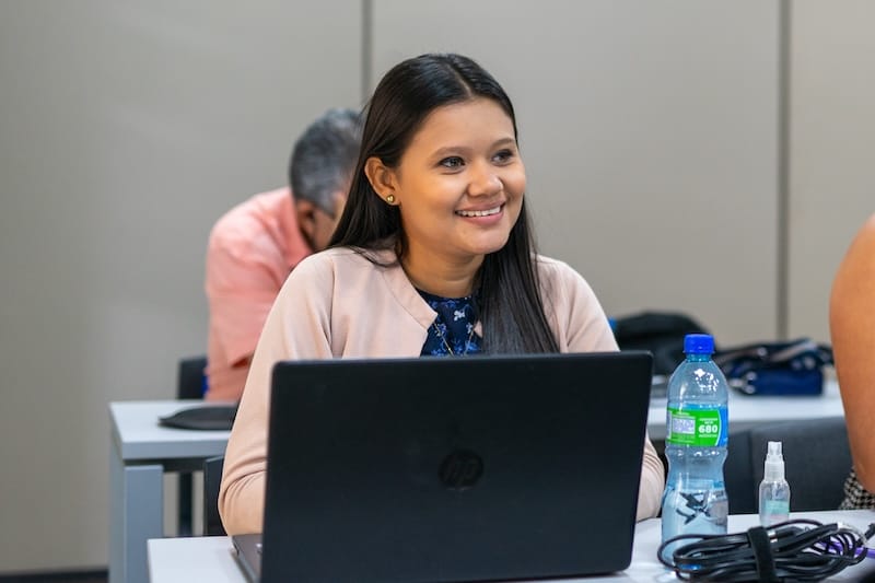 woman at laptop smiling